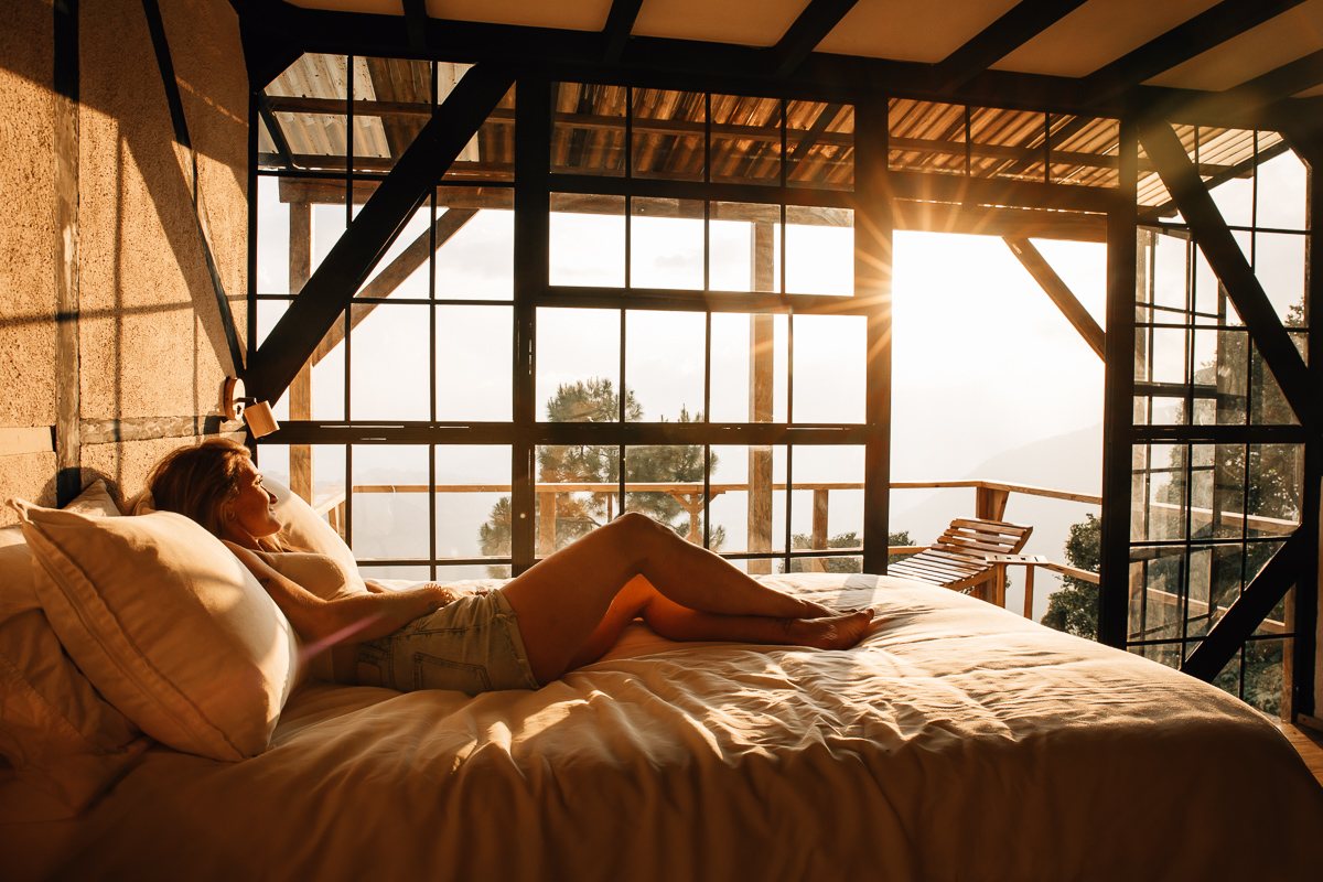 Guest relaxing in Cabaña Aguacate at sunrise, Earth Lodge Guatemala